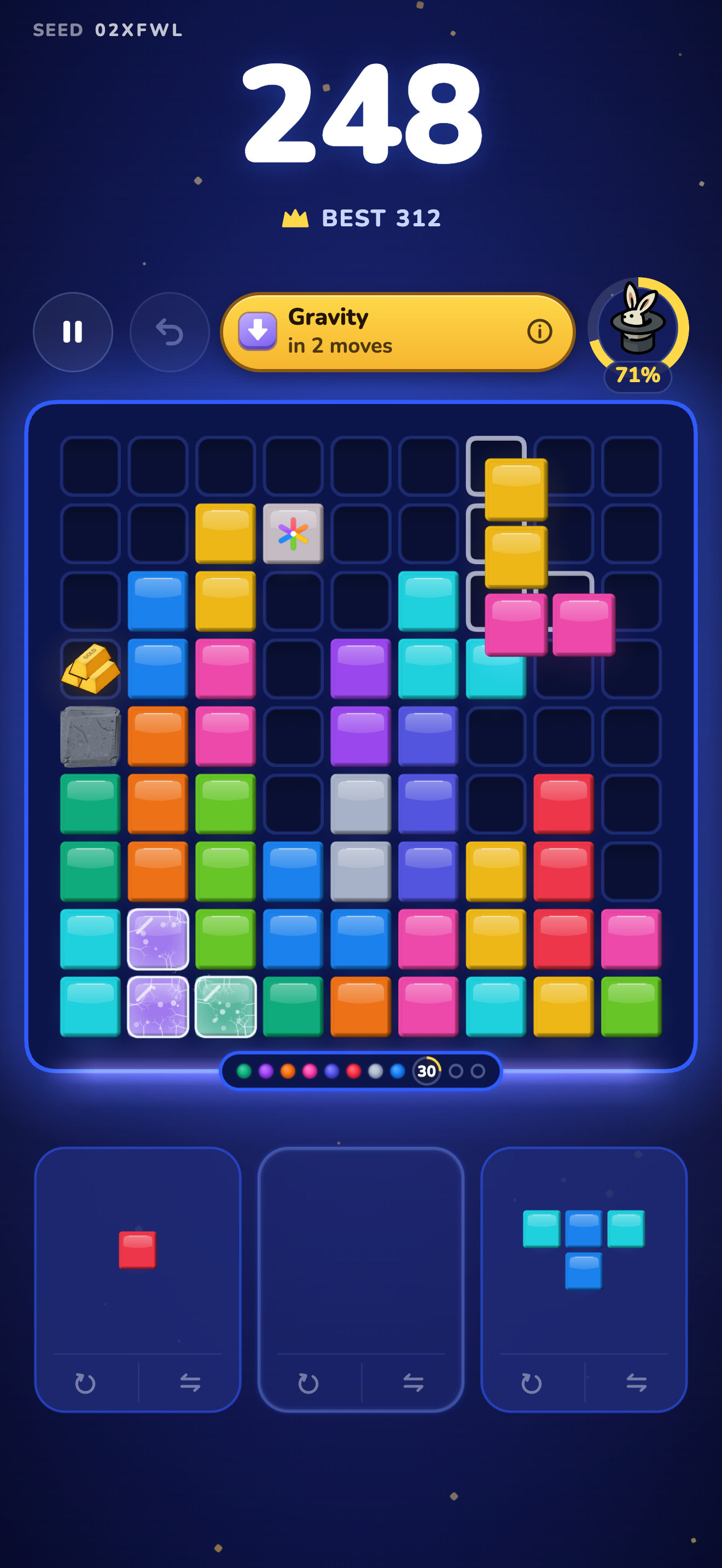 An L-shaped yellow and pink piece being dragged onto the board, with a Gravity event due in 2 moves.